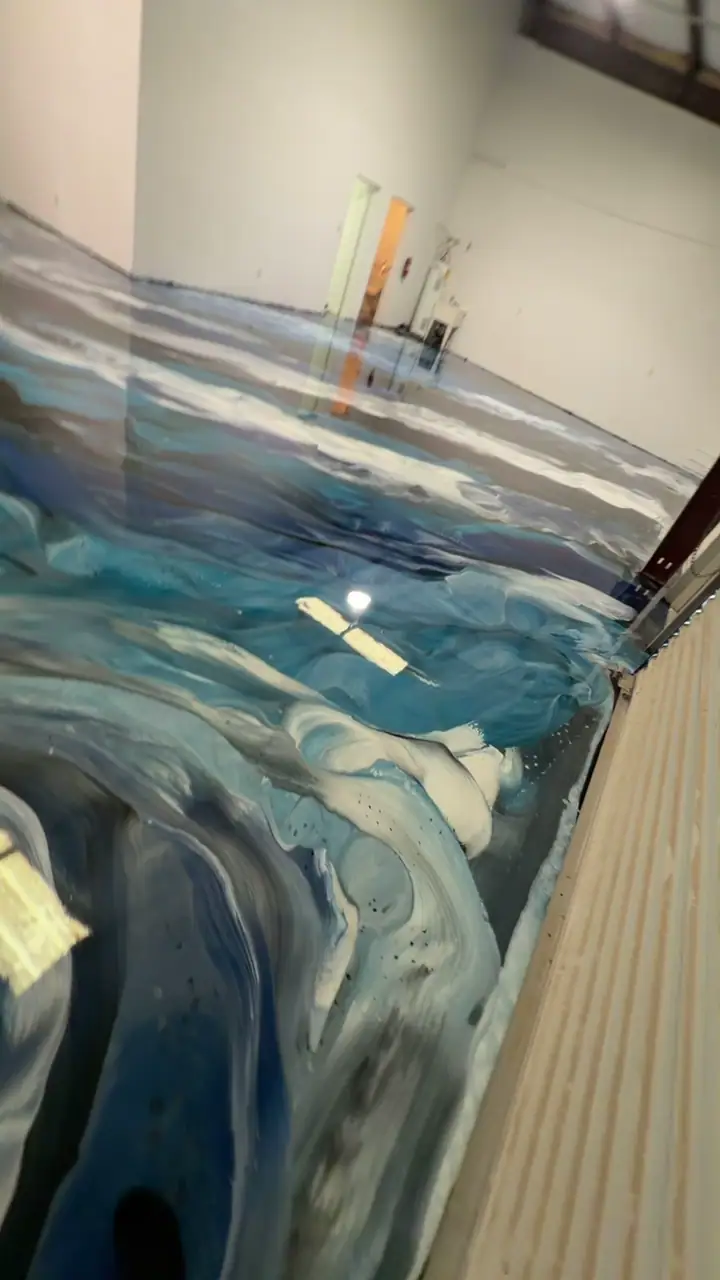 A finished blue, black and white metallic epoxy floor in a warehouse